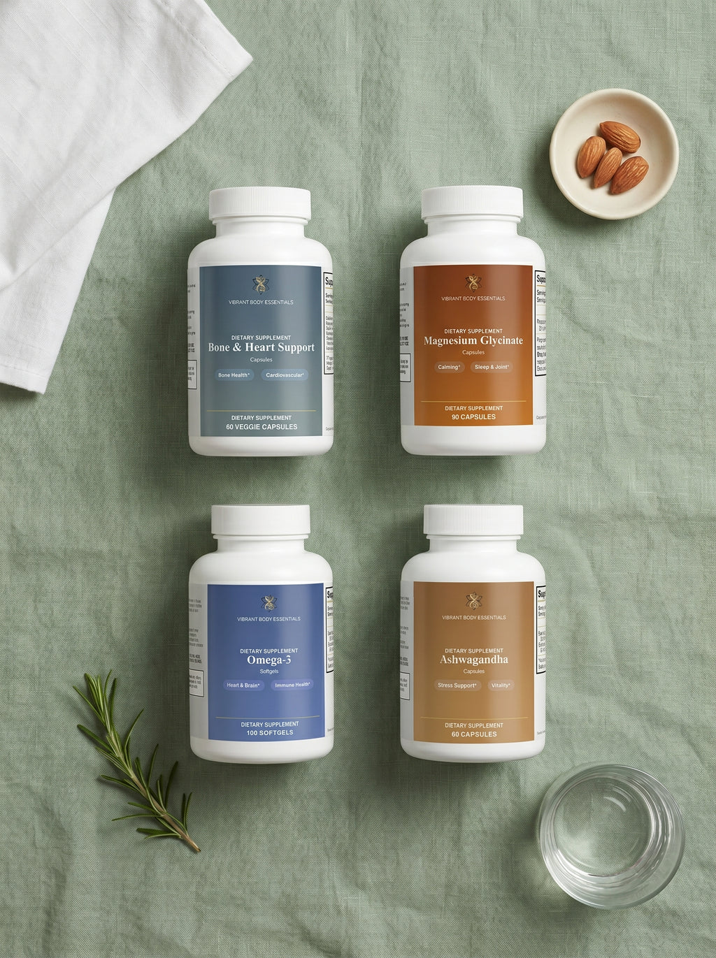 Her Daily Essentials four supplement bottles arranged on sage linen with almonds and rosemary